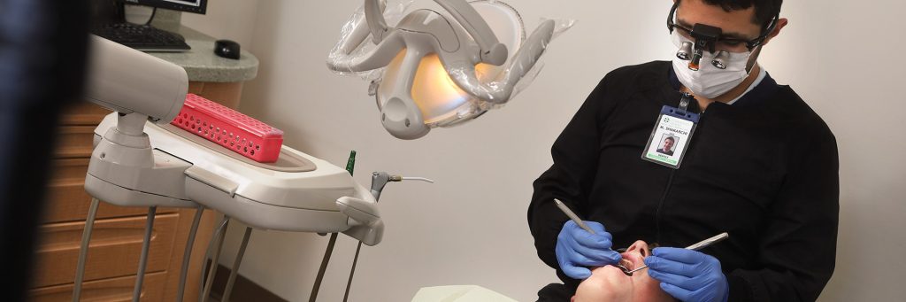 Dr. Mo performs a dental treatment